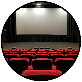 empty movie theatre with lights on and a blank screen